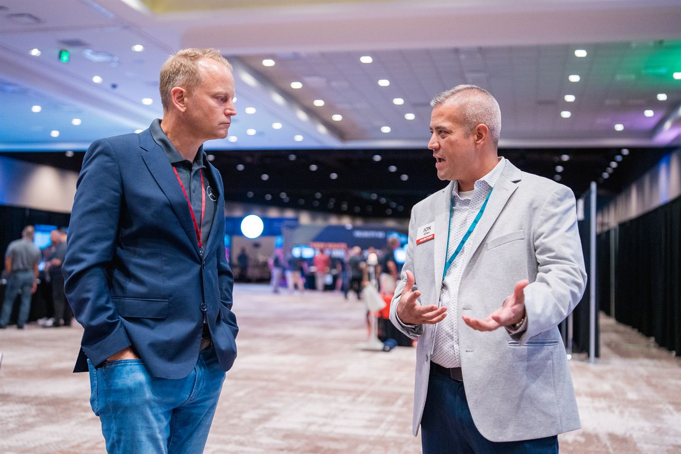 Two attendees talking in the exhibition hallway