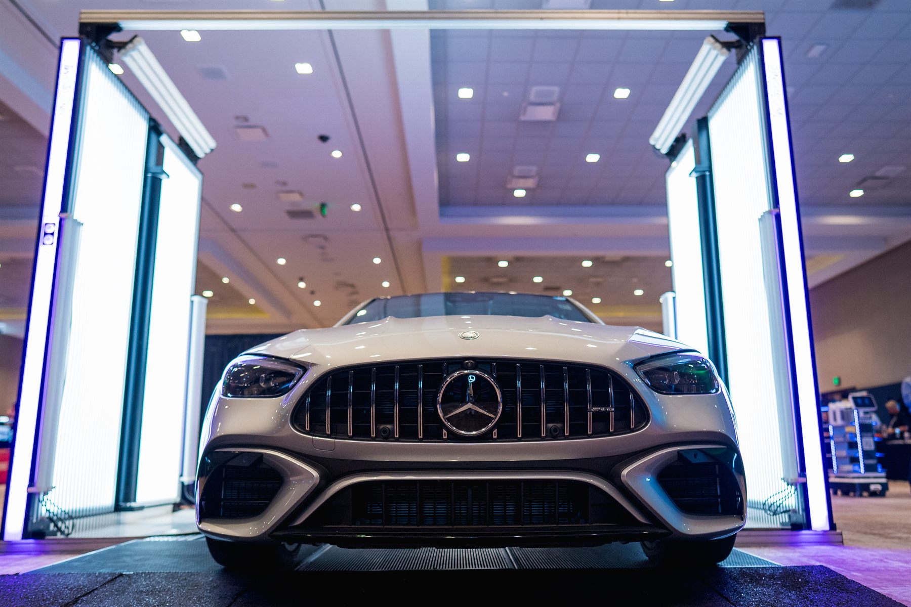A performance sedan framed head-on inside the illuminated scanning gate at the 2025 technical days