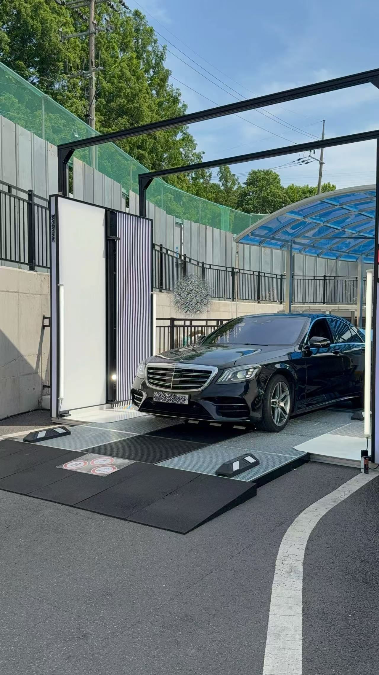 Luxury sedan exiting an outdoor XVD installation in Korea
