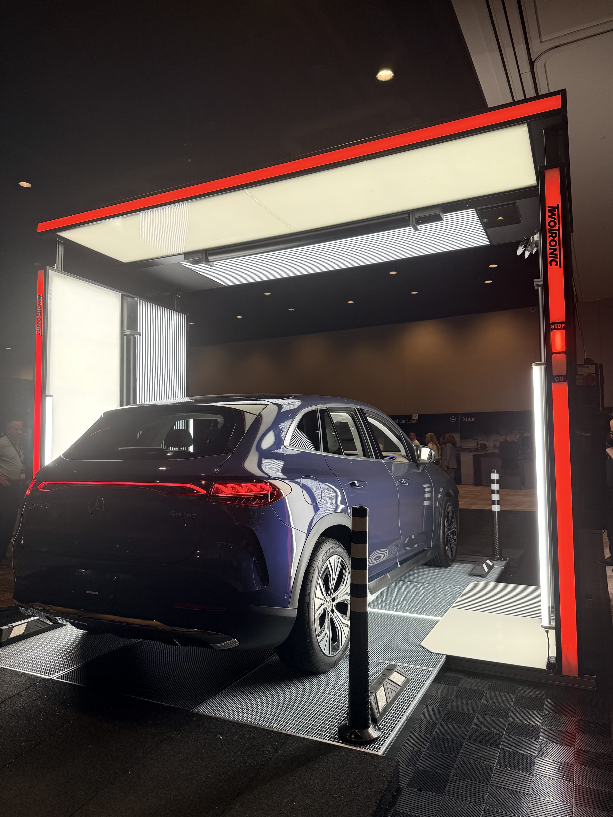 Electric SUV inside the scanning gate with the columns lit red