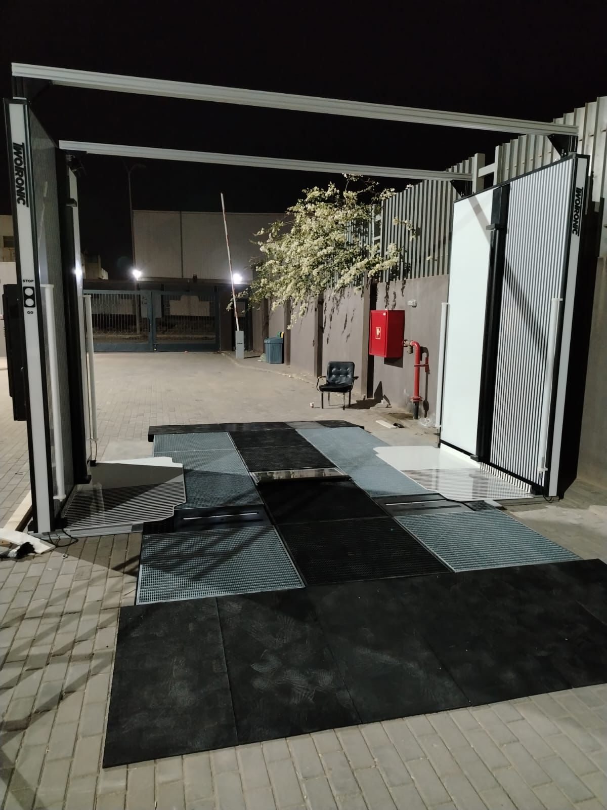Scanning gate illuminated at night at an outdoor site